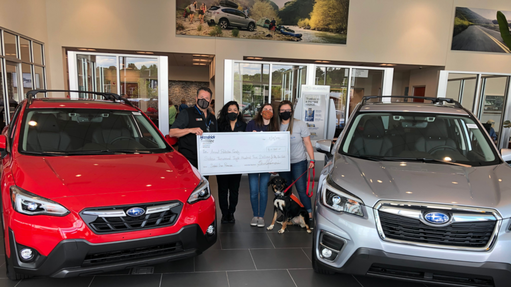 Paws4Ever - Hendrick Subaru Southpoint presenting a large check